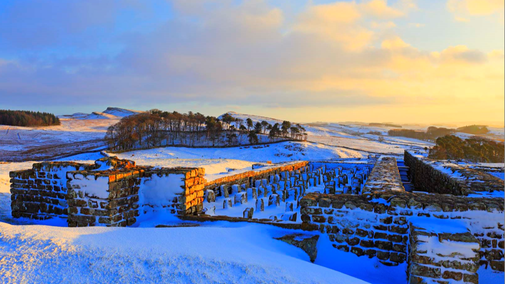 Housesteads Fort under a winter sky and a blanket of snow